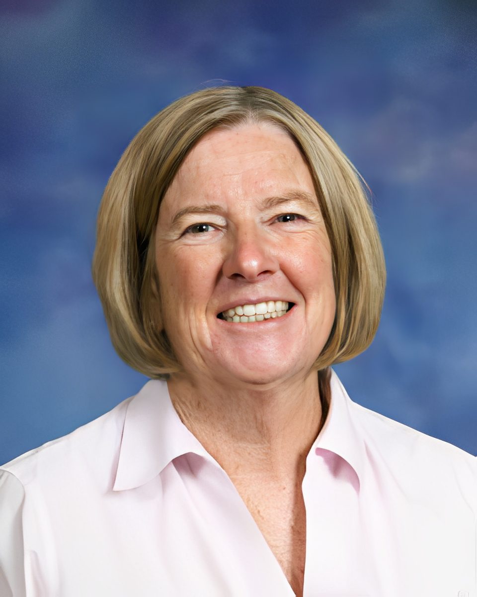 Woman with short blonde hair smiling