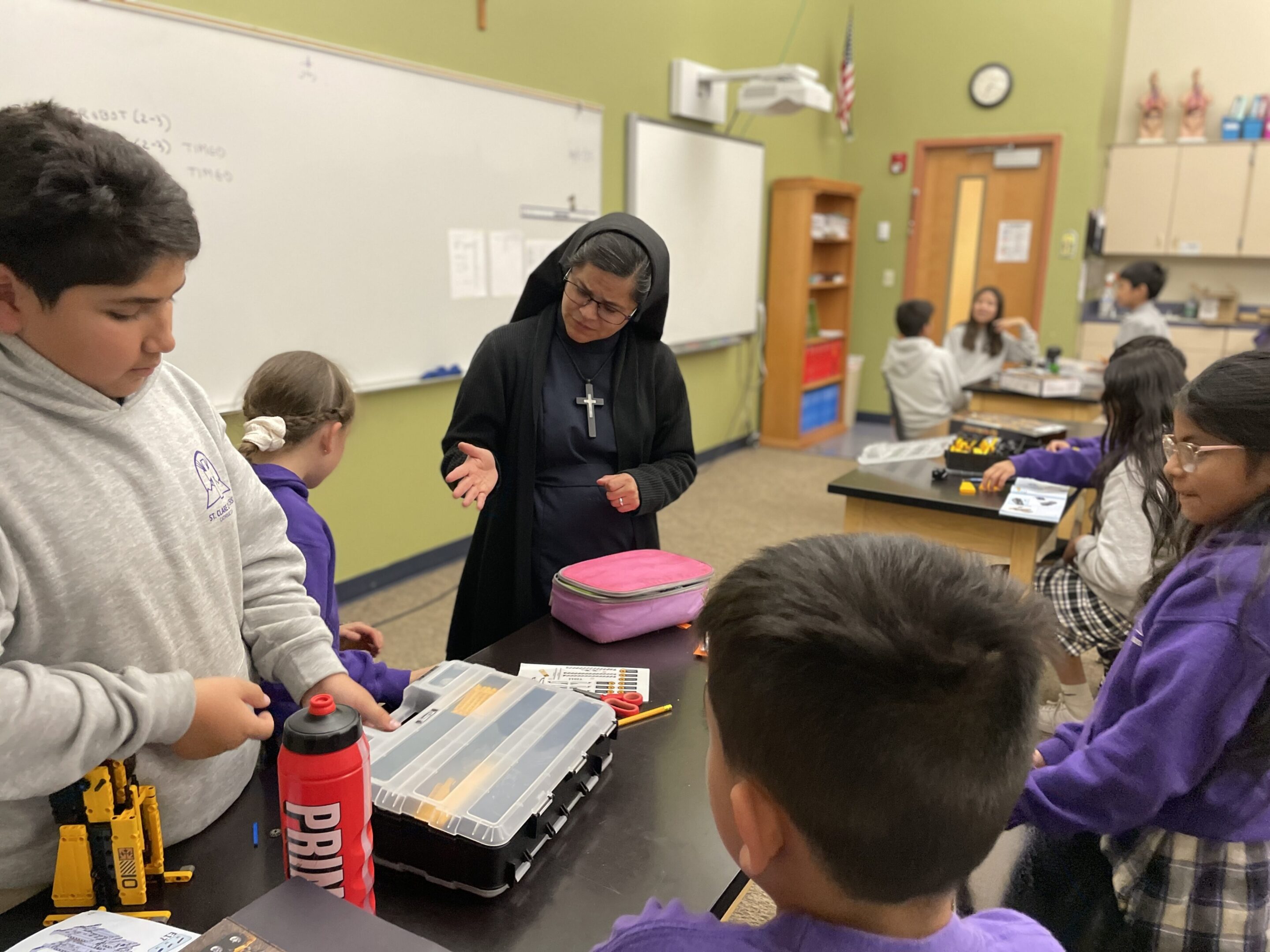 A teacher and students engaged in a classroom activity.