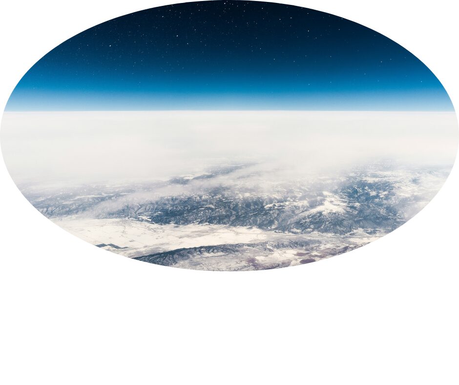 View of Earth's curvature and atmosphere from space above clouds.